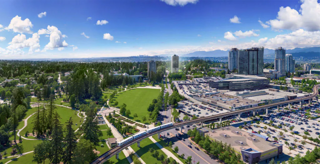 A panoramic view of a vibrant cityscape featuring green parks, tall buildings, and a busy parking area under a bright blue sky with clouds.